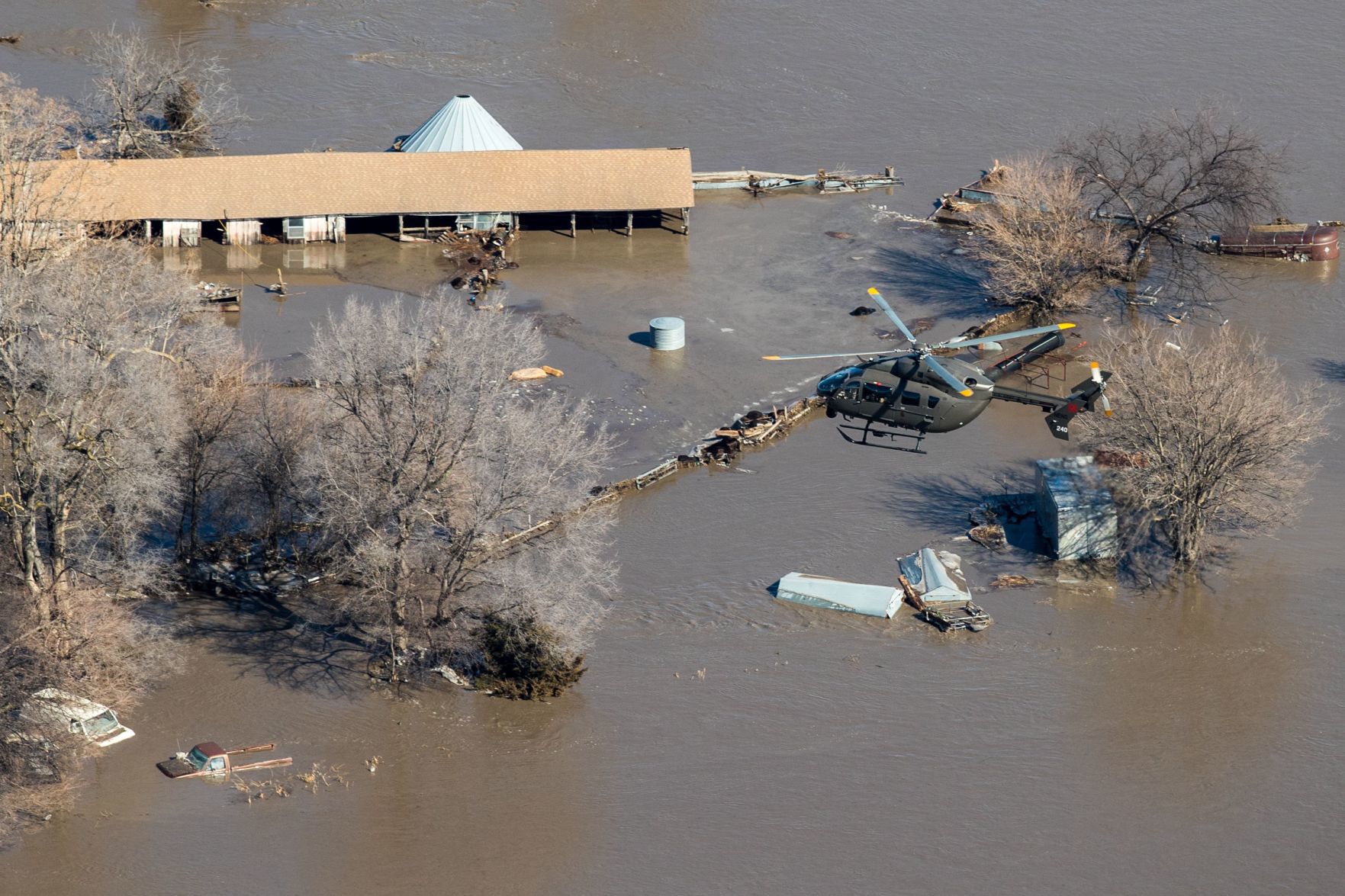 A Nebraska National Guard helicopter flies over areas flooded by the Platte River near Columbus, Nebraska, on Friday.